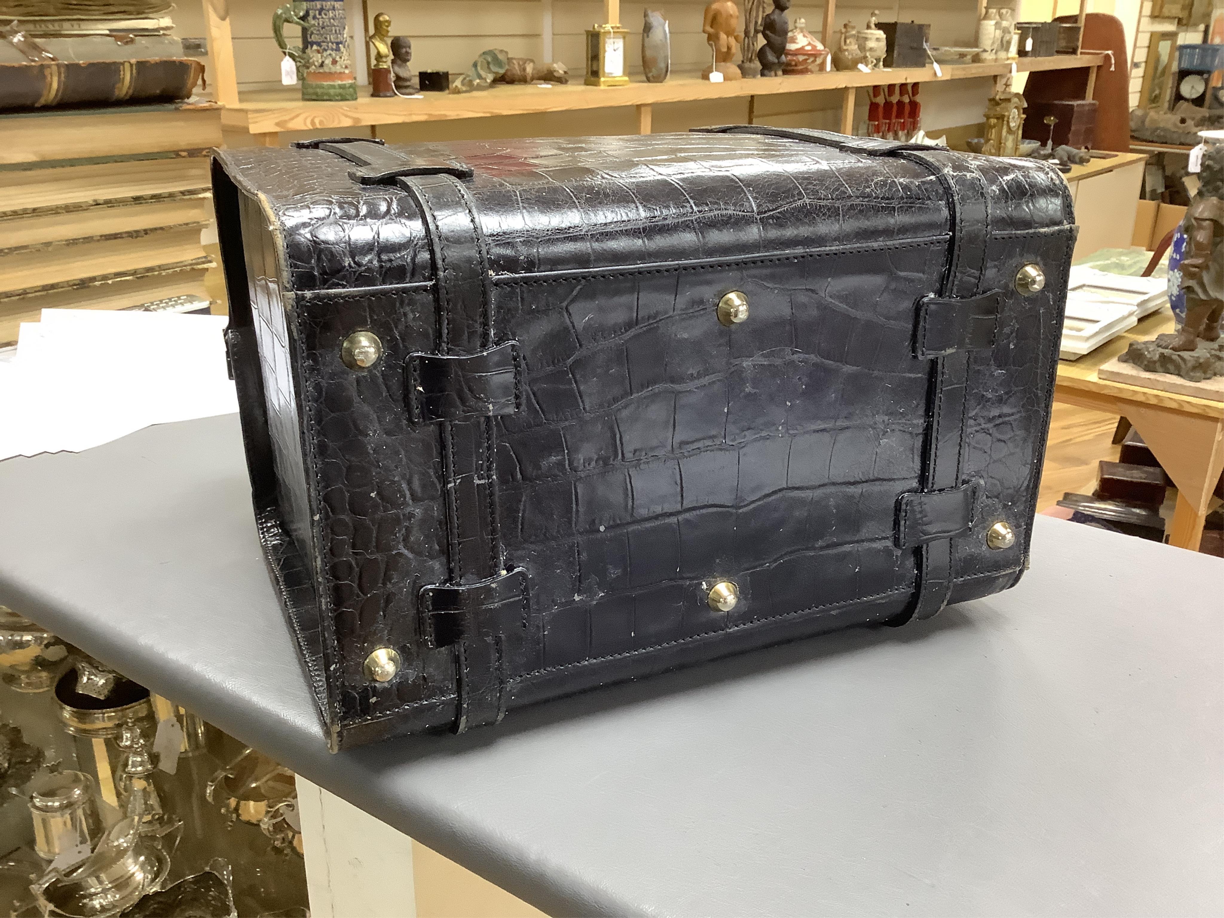 A 1940’s ladies crocodile skin Gladstone bag with gilt metal hardware, 34cm wide